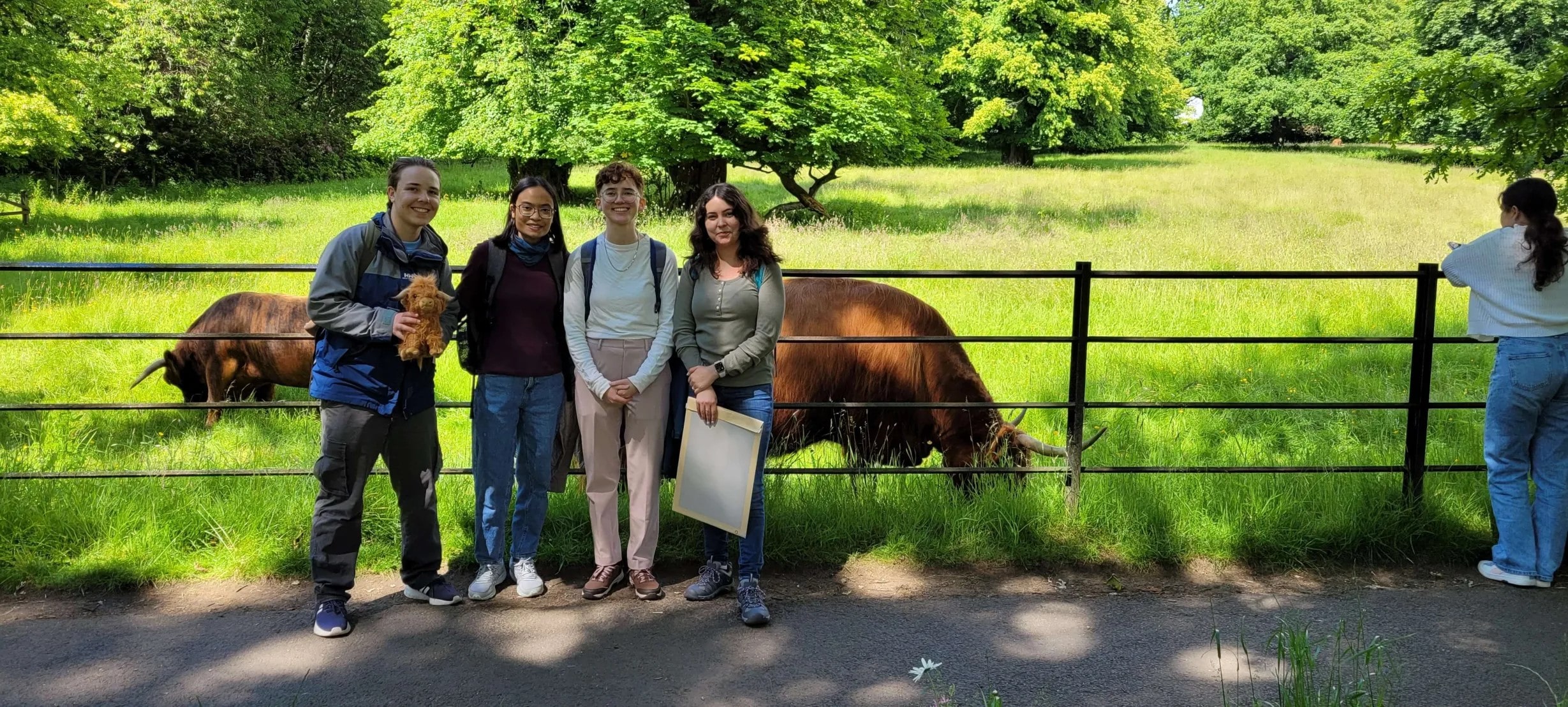 4 students standing in front of animals