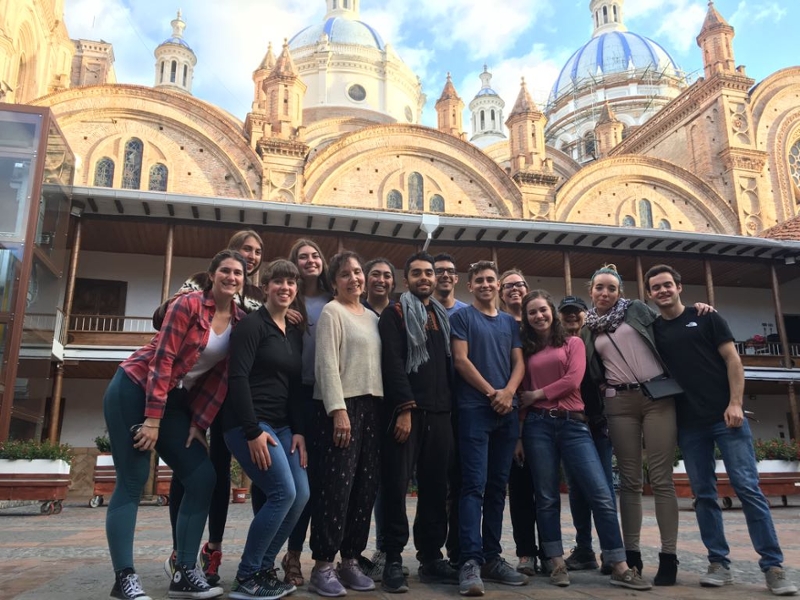 group of students posing in front of old domed architecture