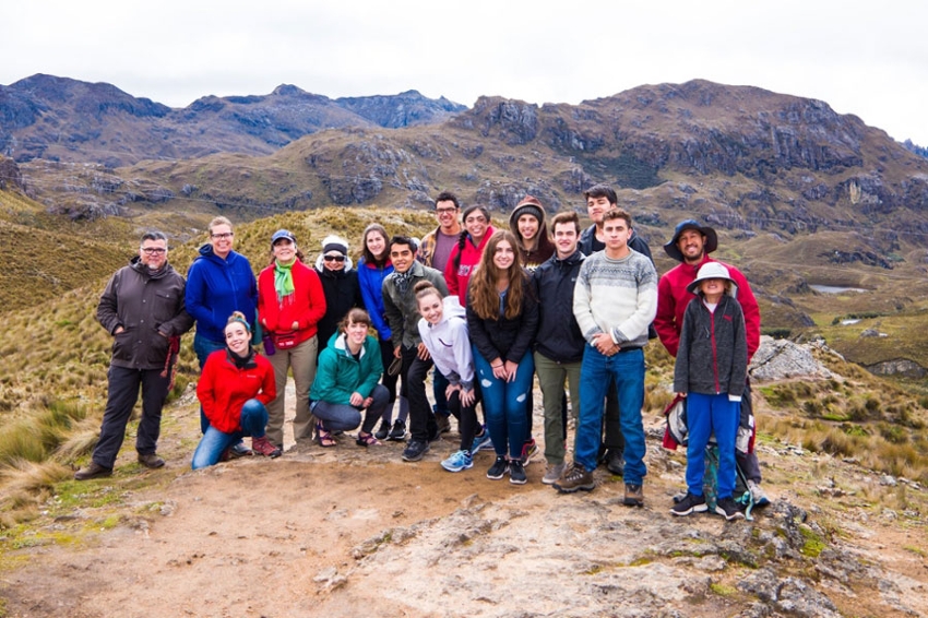 Group of students posing in front of a mountain range