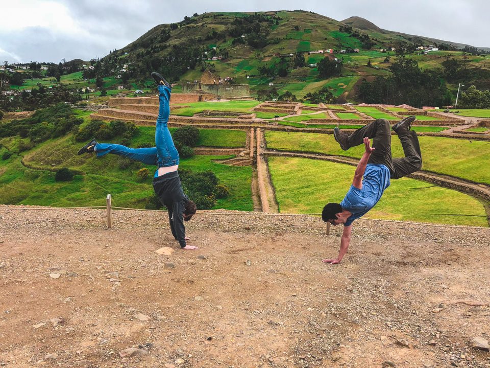 2 students doing a handstand in the ecuador countryside