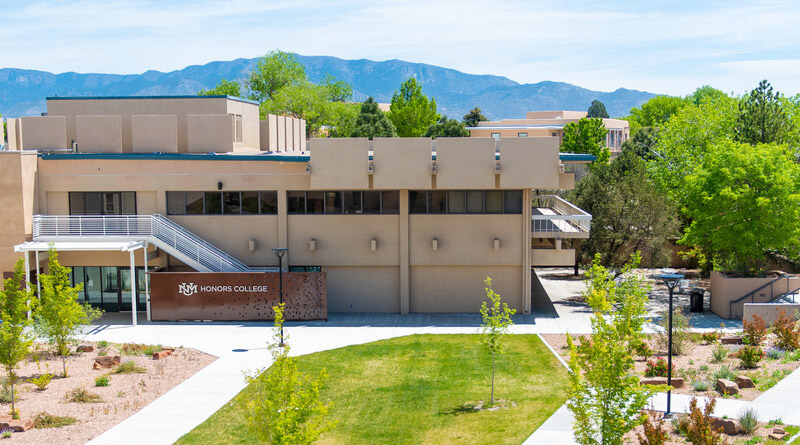 photo of the honors college from above with the mountains in the background
