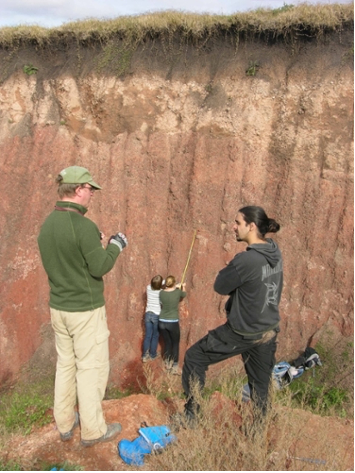 students measuring something in a hillside