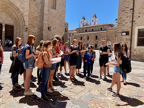 Conexiones students in a stone courtyard in spain