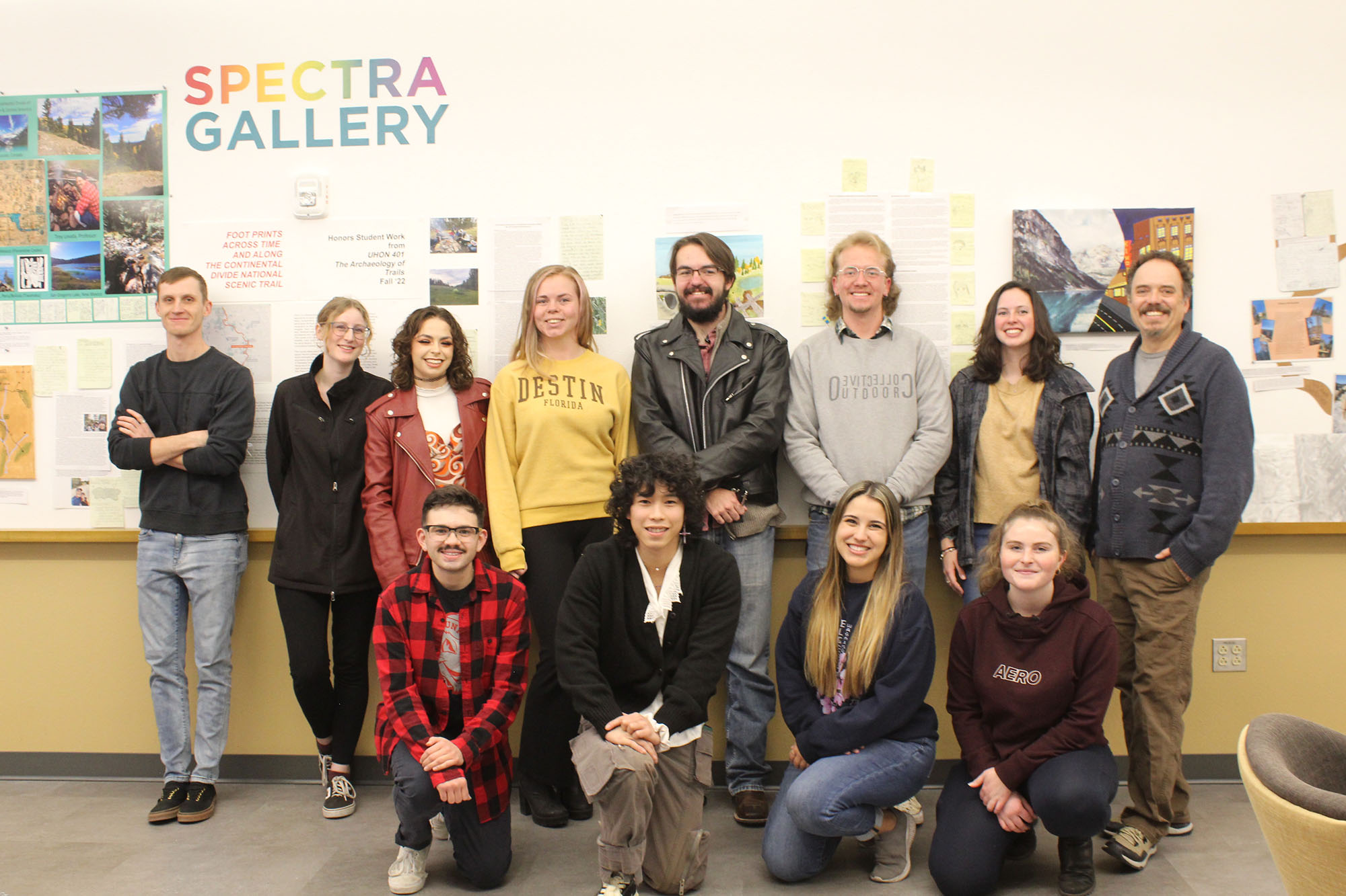a group of students standing in the gallery with the words spectra art gallery on the wall